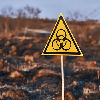 yellow-biohazard-sign-installed-in-scorched-field-2022-05-28-09-09-38-utc